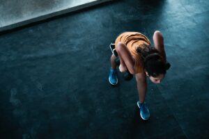 woman in orange top exercising indoors
